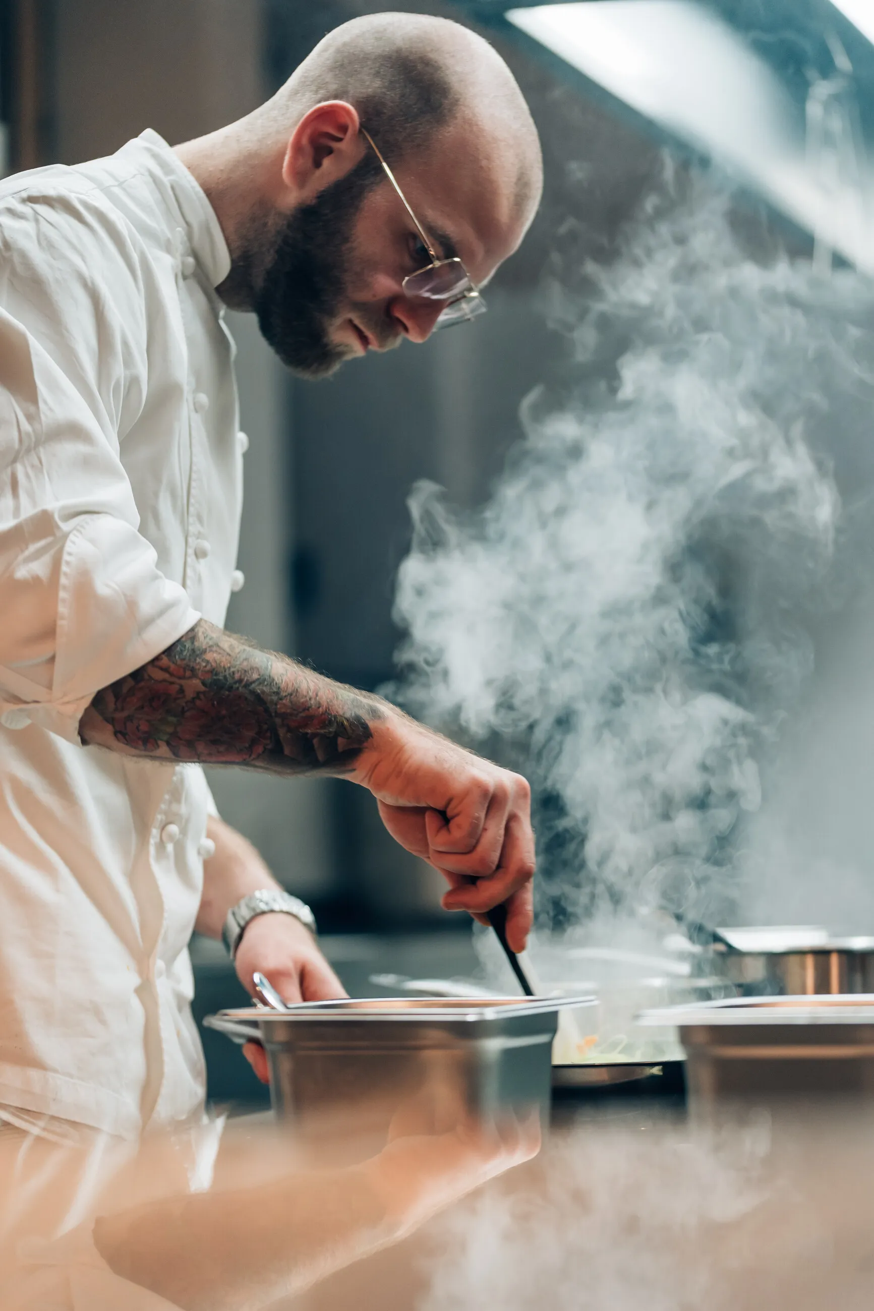 René in the kitchen, steam rising from the stove